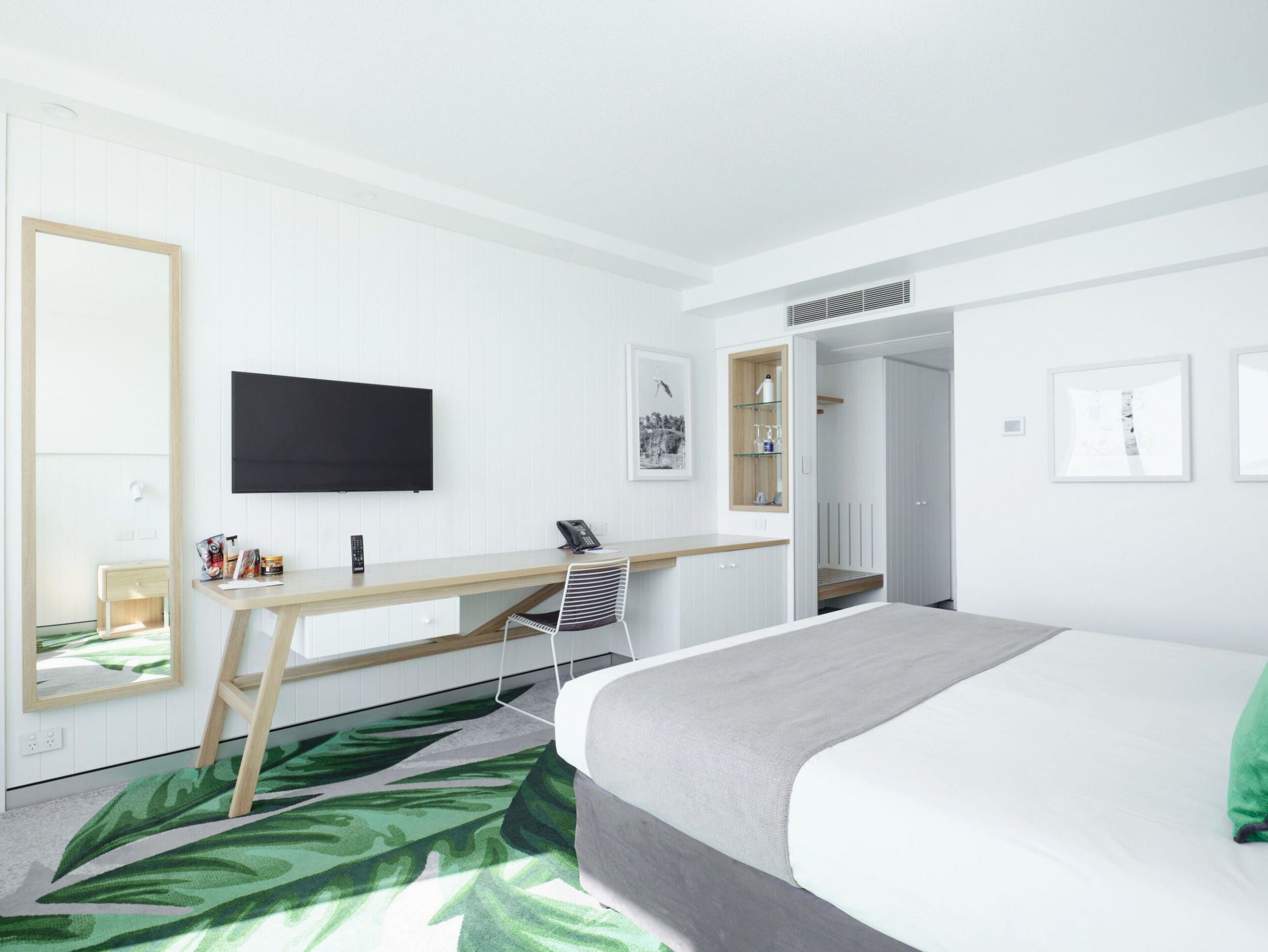 Light-filled resort room interior with tropical Queensland styling at The Ville